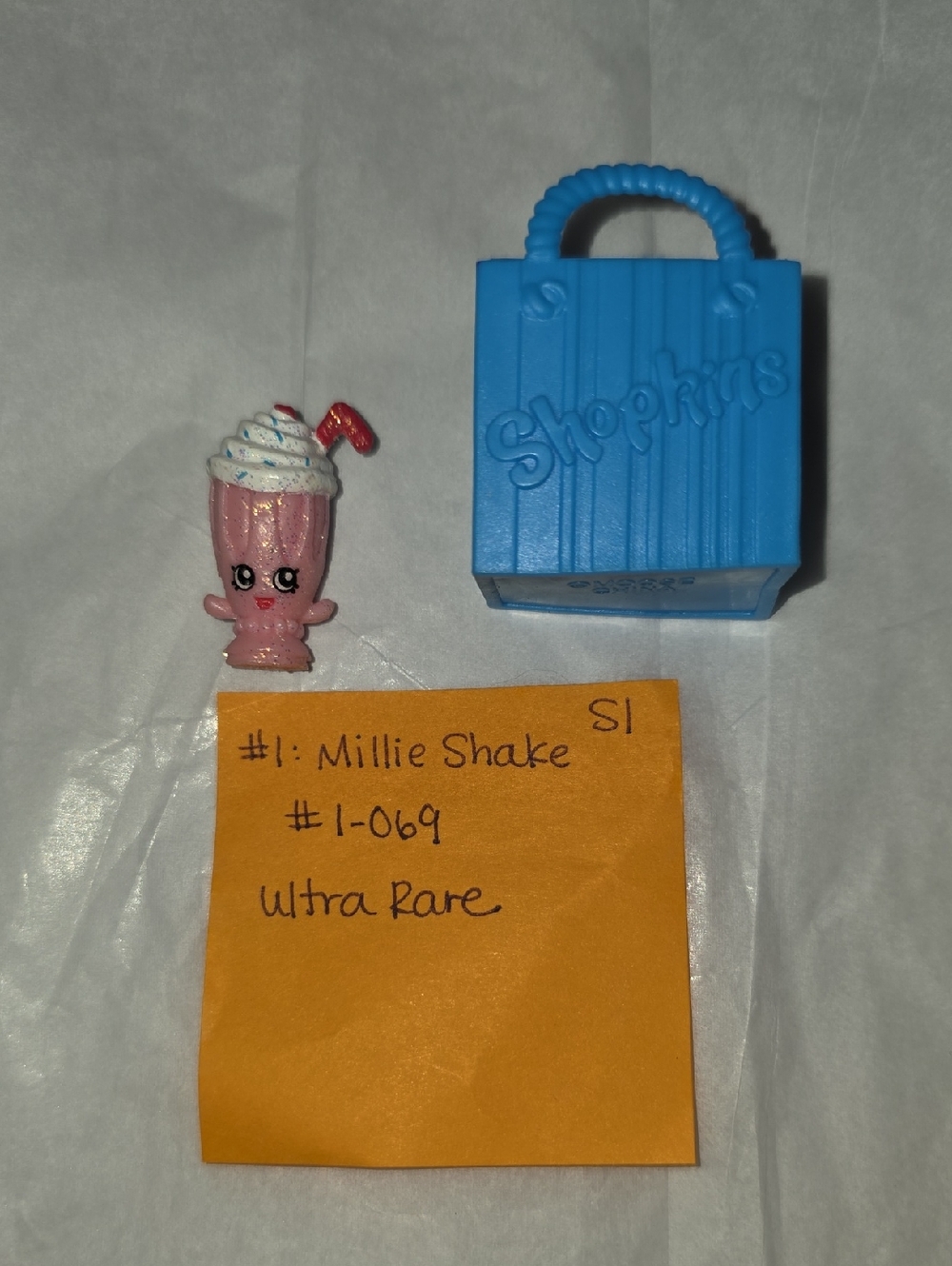 Ultra Rare- Shopkins Millie Shake Pink Figure with Blue Shopkins Bag